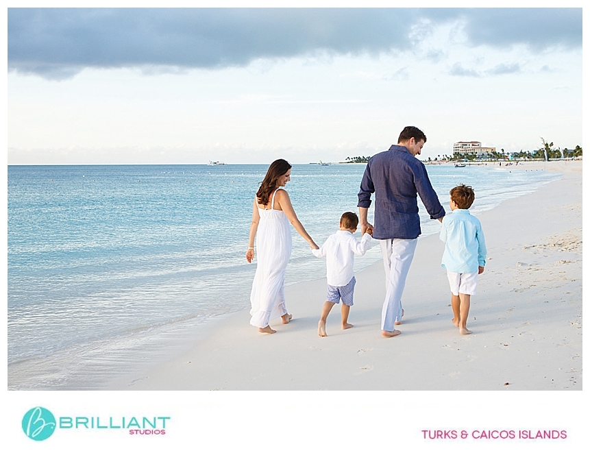 family walking on grace bay bach during a portrait with a turks and caicos photographer