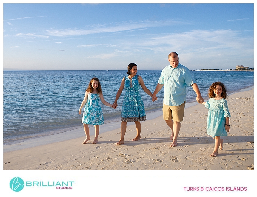 family walking at the beach during a family vacation portrait 