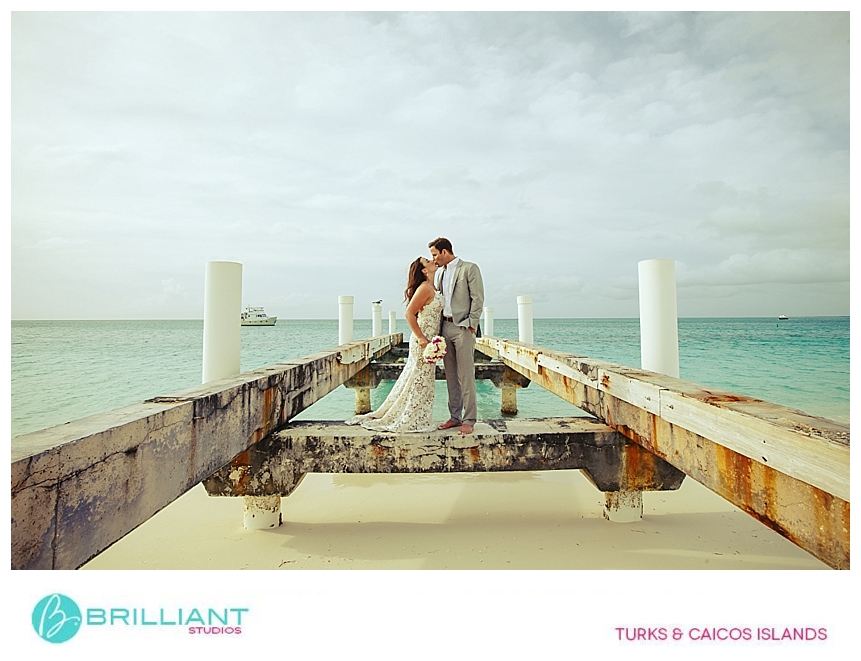 Wedding couple standing on the old dock, Grace Bay