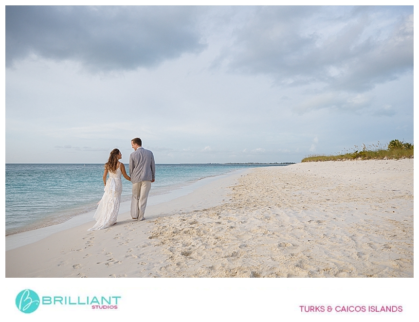 bride and groom walking on the beach 