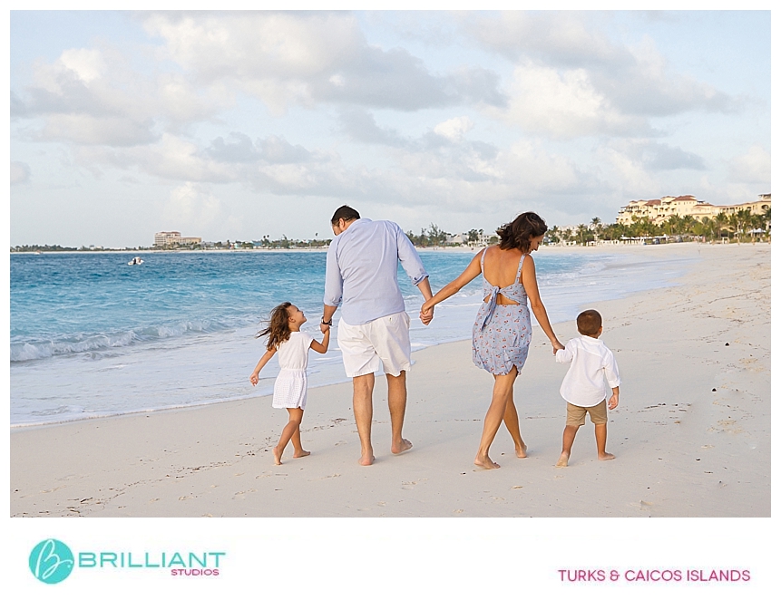 family walking on grace bay beach during a photo shoot 