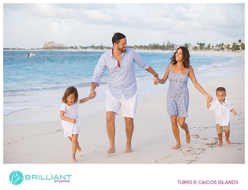 family running at Grace Bay beach during a photo shoot 