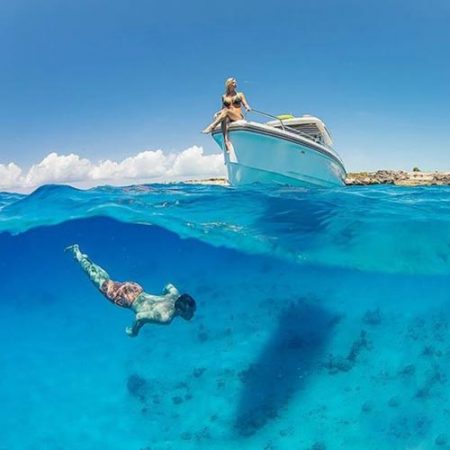 swimming under boat - photographer in Providenciales